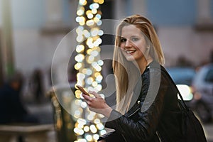 Shes an avid app user. an attractive woman using a mobile phone in the city.