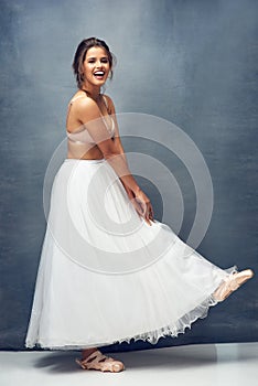 Shes a ballet beauty. Portrait of a beautiful young woman posing in studio while wearing a bra and ballet skirt.