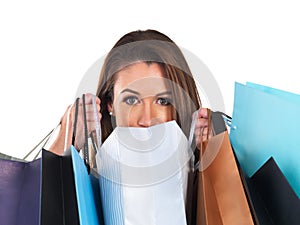 Shes a big spender. Portrait of a young woman carrying shopping bags isolated on white.