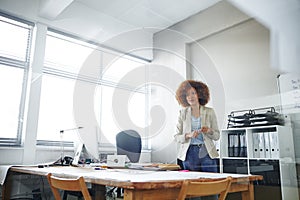 Shes the consummate professional. a businesswoman working in an office. photo