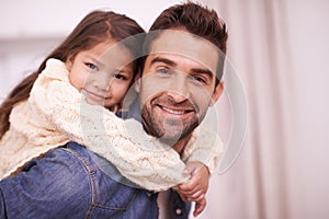 Shes Daddys little princess. a father giving his daughter a piggyback ride at home.