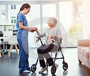 Shes dedicated to her patients. Full length shot of a young female nurse talking to her senior patient in the old age