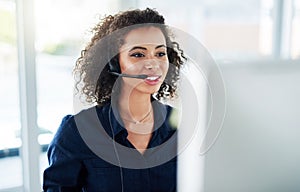 Shes determined to help as many customers as possible. Cropped shot of an attractive young female call center agent