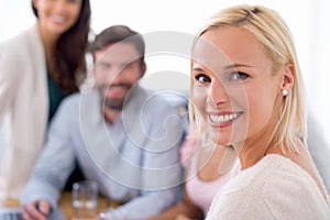 Shes excited about her future business opportunities. Portrait of a smiling beautiful business woman in a team meeting