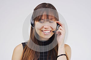 Shes fluent in the companys brand. Studio shot of an attractive young female customer service representative wearing a
