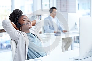 Shes so good at her job. a young call centre agent taking a break while working in an office.