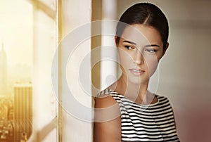 Shes got big ideas for this company. a businesswoman looking out of a window in her office.