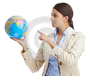 Shes got the businessworld in her hands. an attractive young businesswoman pointing to a globe.