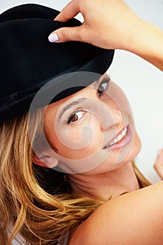 Shes got style. A gorgeous young woman wearing a hat and glancing at you.