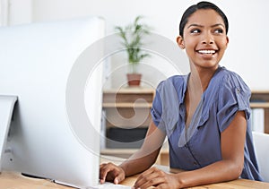 Shes got talent and drive. a young african american woman working at her computer in the office.