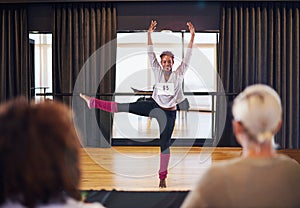 Shes got talent. a female dancer performing before the judges during a dance audition.