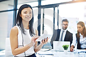 Shes got technology on her side. Cropped portrait of an attractive young businesswoman using a digital tablet in an