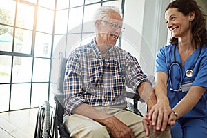 Shes a great caregiver. a female nurse talking to a senior patient in the retirement home.