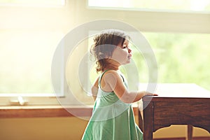 Shes a happy little cutie. an adorable little girl playing at home.