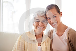 Shes my rock. Portrait of a smiling young woman and her senior mother bonding.