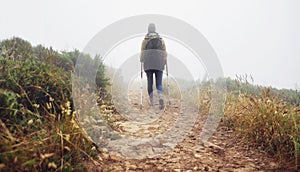 Shes one determined hiker. Rear view of a female hiker walking along a hiking trail.