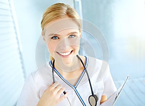 Shes prepared to be the best. Portrait of a pretty nurse with her stethoscope holding a medical file with copyspace.