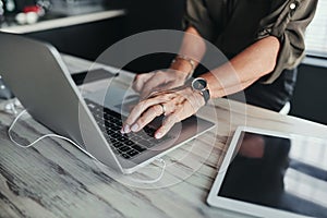 Shes quite the keyboard warrior. High angle shot of an unrecognizable businesswoman working on her laptop in the office.