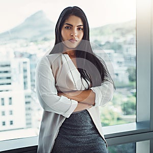 Shes seriously determined about succeeding. Portrait of a confident young businesswoman standing in an office.