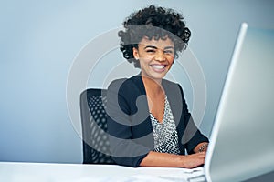 Shes succeeding on every level. Portrait of a businesswoman sitting at her computer in an office.
