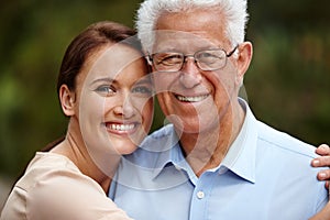 Shes there for her dad in his senior years. Cropped portrait of a happy senior man standing beside his adult daughter.