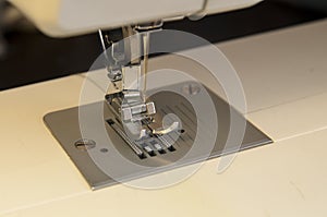 Shewing machine with yellow meter in background