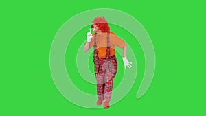 Shh, be quiet Clown making silence gesture while walking on a Green Screen, Chroma Key.