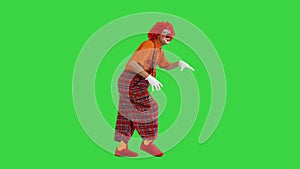 Shh, be quiet Clown making silence gesture while walking on a Green Screen, Chroma Key.