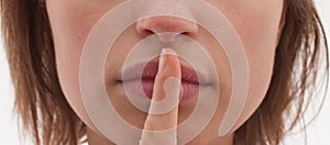 Shh - Cut out of woman with finger to lips photo