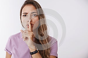 Shh keep secret safe. Serious-looking concerned bothered attractive young 25s woman cannot hear speech telling quiet