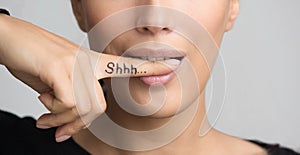 Shh! Women`s Secrets. Woman Biting Finger, Closeup