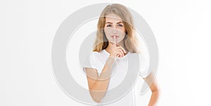 Shhh sign. Young woman showing shh gesture to keep a silent. Girl in template white t shirt keep a secret. Quiet place and silence