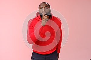 Shhh it taboo. Portrait sensual funny cute african-american bearded man in red hoodie bending camera show shush gesture