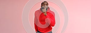 Shhh it taboo. Portrait sensual funny cute african-american bearded man in red hoodie bending camera show shush gesture