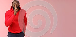 Shhh it taboo. Portrait sensual funny cute african-american bearded man in red hoodie bending camera show shush gesture