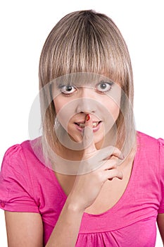 Shhh... Young woman with her finger on lips.