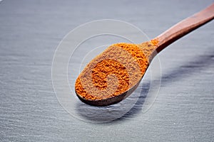 Shichimi pepper in Wooden spoon on black plate,