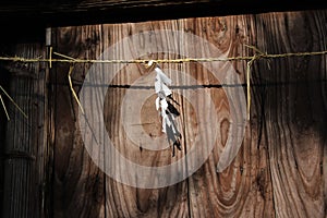 Shide paper hanged on Shimenawa rope around a building