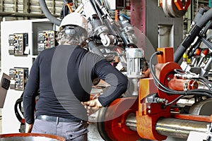 Shief engineer setting up the machine steel cutting machine, steel bar, bending