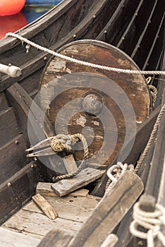 Shield and ropes onboard a recreated viking long boat photo