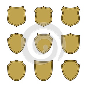 Shield shape gold icons set. Simple flat logo on white background. Symbol of security, protection, safety, strong