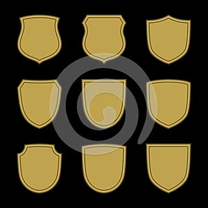 Shield shape gold icons set. Simple silhouette flat logo on black background. Symbol of security, protection, safety
