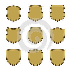 Shield shape gold icons set. Simple silhouette flat logo on white background. Symbol of security, protection, safety