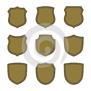 Shield shape gold icons set. Simple silhouette flat logo on white background. Symbol of security, protection, safety