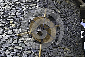 Shield, spear, helmet on a stone tower