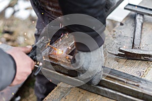 Shielded metal arc welding. Worker welding metal with electrodes, wearing protective helmet and gloves. Close up of electrode