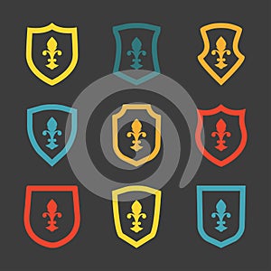 Shields icon set with fleur-de-lis symbol. Heraldic royal design. Vector illustration