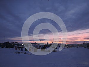 In the shift camp, builders are preparing for the New Year. From the snow make the letters `Happy New Year!`