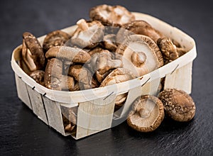 Shiitake mushrooms on a vintage slate slab, selective focus