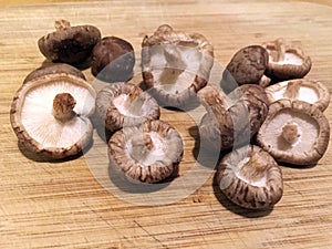 Shiitake mushrooms on a wooden chopping board